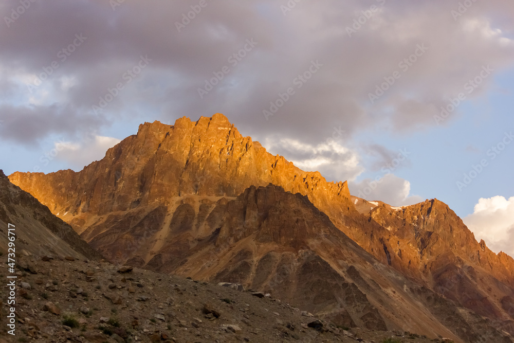 Evening light hitting the barren brown mountains of the Zanskar range in the Himalayan region of Ladakh.
