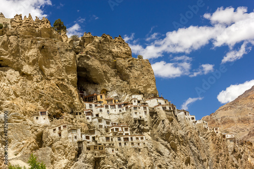 The ancient Tibetan Buddhist Phuktal monastery of on a steep rocky hillside in the Zanskar region in Ladakh in the Indian himalaya. photo