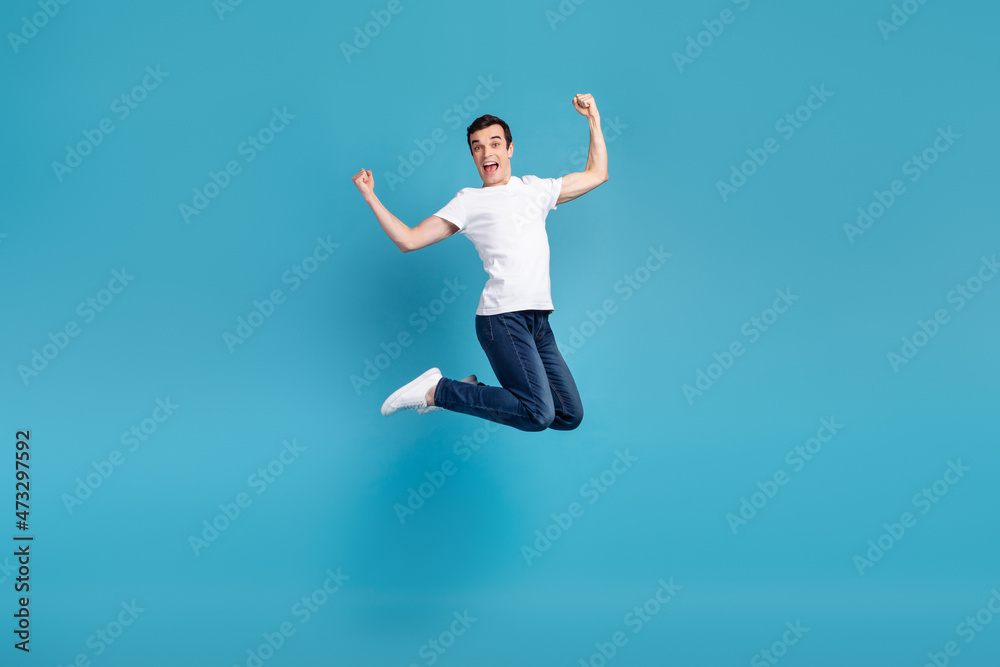 Full body photo of young excited man have fun jumper rejoice victory success isolated over blue color background