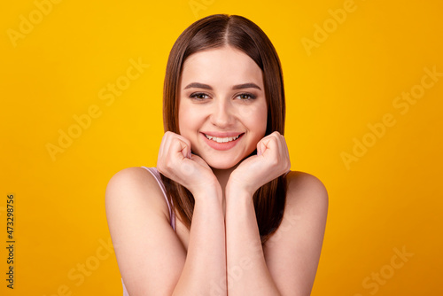 Photo of young lovely girl arms touch cheeks dreamy teeth oral care isolated over yellow color background