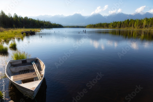 Old wooden boat on the shore of a mountain lake © Shchipkova Elena