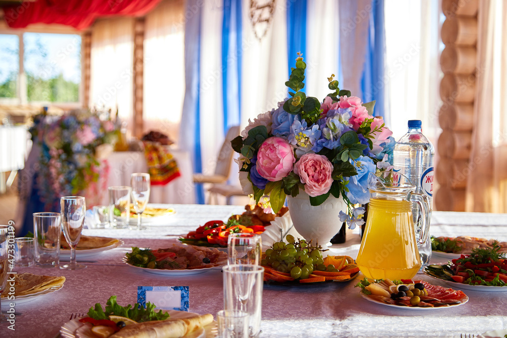 Bouquet of flowers on banquet table. Decoration in wedding restaurant