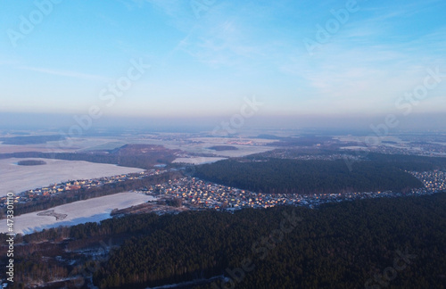 Aerial view of winter snowy landscape with forest and field © Payllik