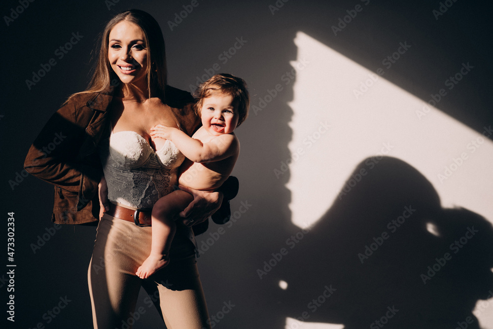 Young beautiful mother with her small child,practicing breast feeding Young beautiful mother with her small child,practicing breast feeding