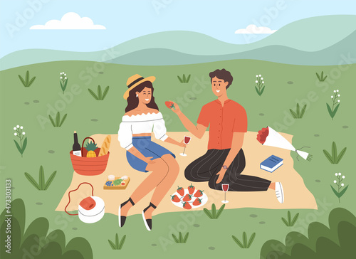 Couple have romantic picnic in meadow