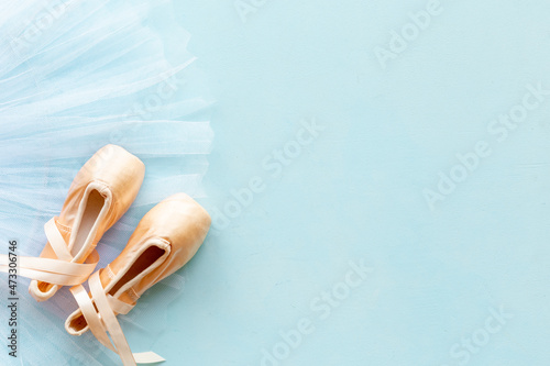 White ballet tutu skirt and beige pointe shoes with ribbon © 9dreamstudio