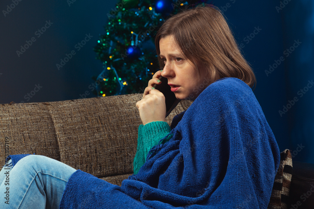 Better to stay alone when you feel sick at the pandemic time and celebrate Christmas in quarantine. Woman alone at home with Christmas tree, feeling sick, quarantine on new year's eve. Better to stay alone when you feel sick at the pandemic time and celebrate Christmas in quarantine. Woman alone at home with Christmas tree, feeling sick, quarantine on new year's eve.