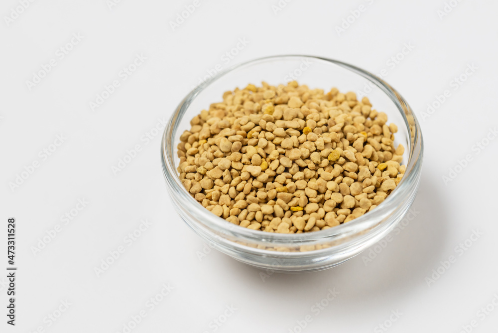 Macro photo of flower bee pollen in a glass cup on white Macro photo of flower bee pollen in a glass cup on white