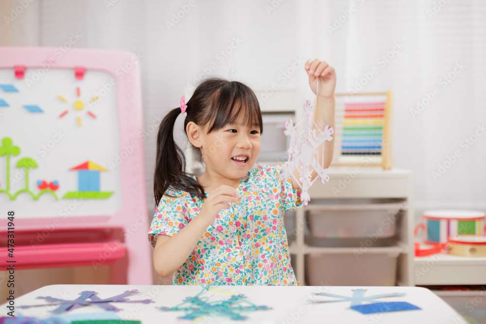 young girl making snow flakes craft for homeschooling young girl making snow flakes craft for homeschooling