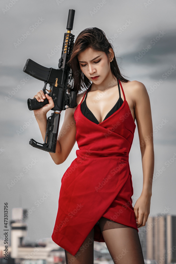 Woman in red aiming a gun