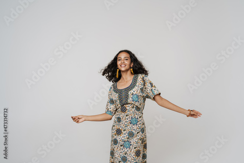 Young south asian woman wearing dress dancing on camera