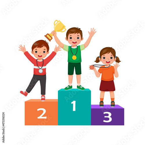 Kids with medals holding gold cup trophy standing on winners podium or pedestal  with first, second and third place prize celebrating winning competition