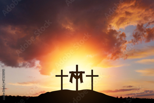 Christian easter scene, He is risen. mount Calvary and three silhouettes of crosses at sunrise. Banner for Easter