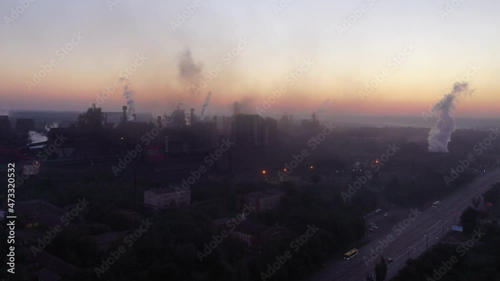 Air pollution and soot in many factory chimneys in city area. Drone shot of industrial zone with thick smog and burning fossil fuels. Shooting early in the morning Air pollution and soot in many factory chimneys in city area. Drone shot of industrial zone with thick smog and burning fossil fuels. Shooting early in the morning