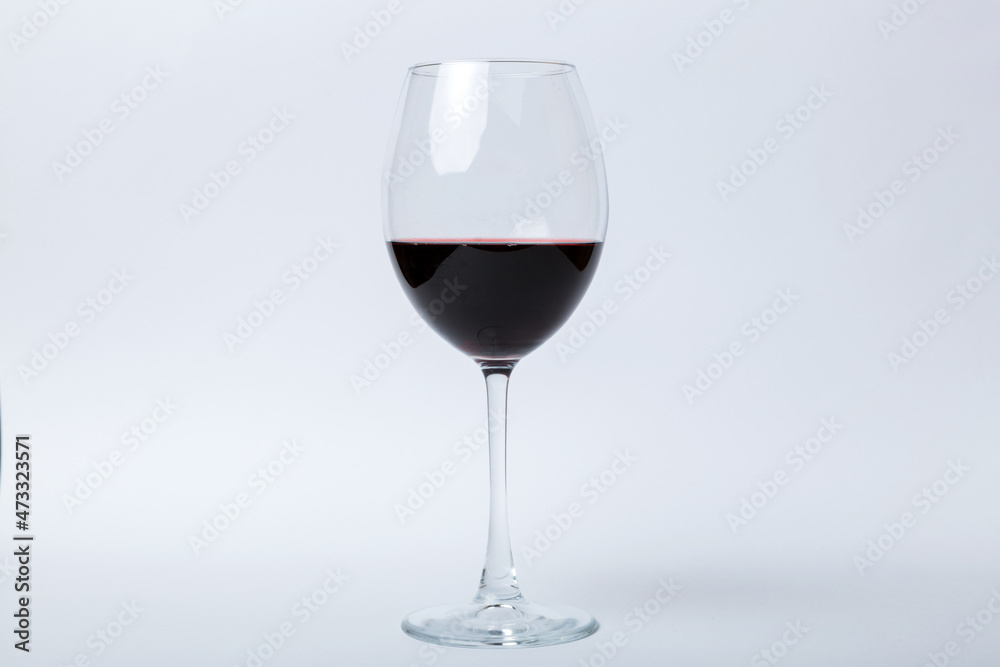 One glasses of red wine at wine tasting. Concept of red wine on colored background. Top view, flat lay design One glasses of red wine at wine tasting. Concept of red wine on colored background. Top view, flat lay design
