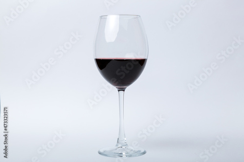 One glasses of red wine at wine tasting. Concept of red wine on colored background. Top view  flat lay design