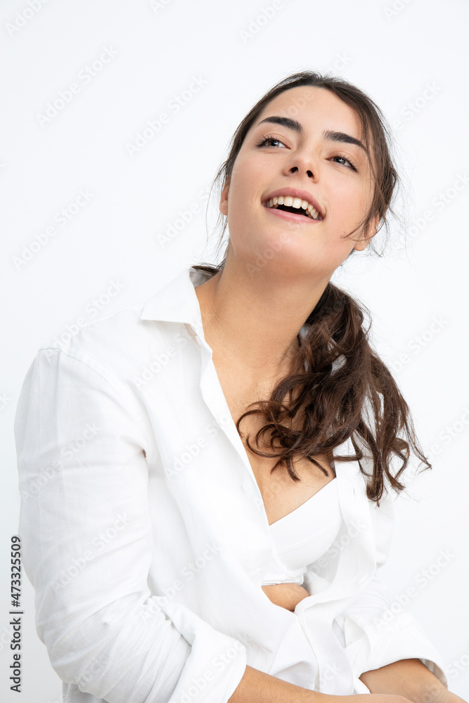Smiling sensuous young woman against white background Smiling sensuous young woman against white background