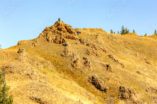 portrait of a mature tourist traveling along the Nurali ridge in the Ural mountains on an autumn sunny day. photo