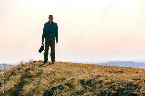 portrait of a mature tourist traveling along the Nurali ridge in the Ural mountains on an autumn sunny day. photo