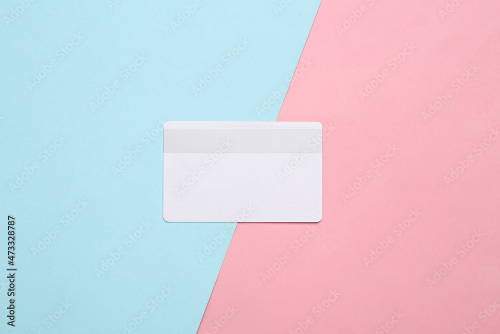 White bank card on blue pink pastel background White bank card on blue pink pastel background