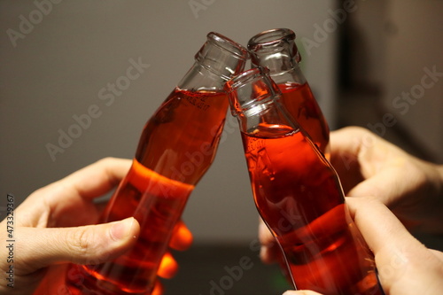 Slika na platnu orange cocktail in glass bottles - aperitive drink