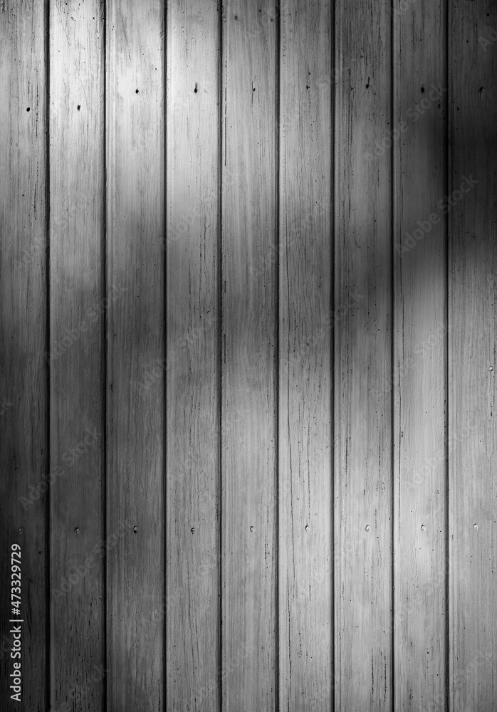 Obraz premium Front view of an old weathered and painted wooden wall or wood paneling. Abstract high resolution full frame textured background in black and white.