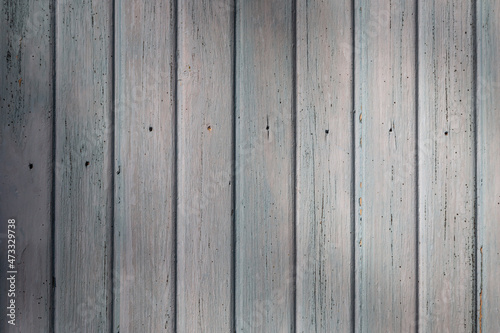 Front view of an old weathered and painted wooden wall or wood paneling. Abstract high resolution full frame textured background.