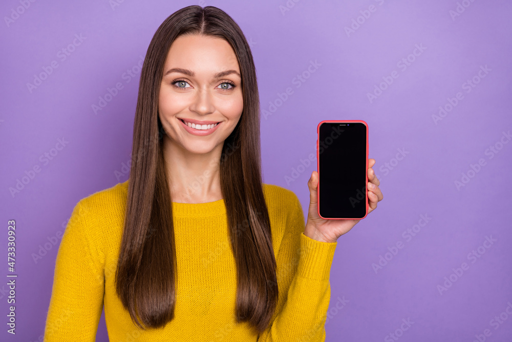 Photo of young pretty lady show cellphone advert recommend suggest isolated over purple color background Photo of young pretty lady show cellphone advert recommend suggest isolated over purple color background