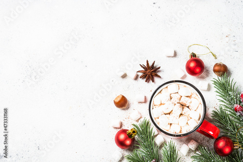 Christmas drink. Hot chocolate with marshmallow and gingerbread cookies with holiday decorations at white table. Top view with copy space. photo