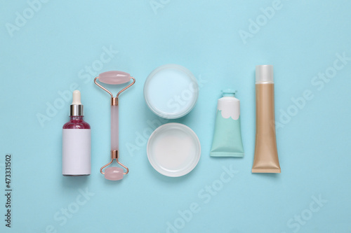 Set of cosmetics and tools for skin care on a blue background. Flat lay