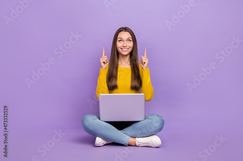 Full size photo of young girl indicate fingers empty space promo select ad laptop isolated over violet color background