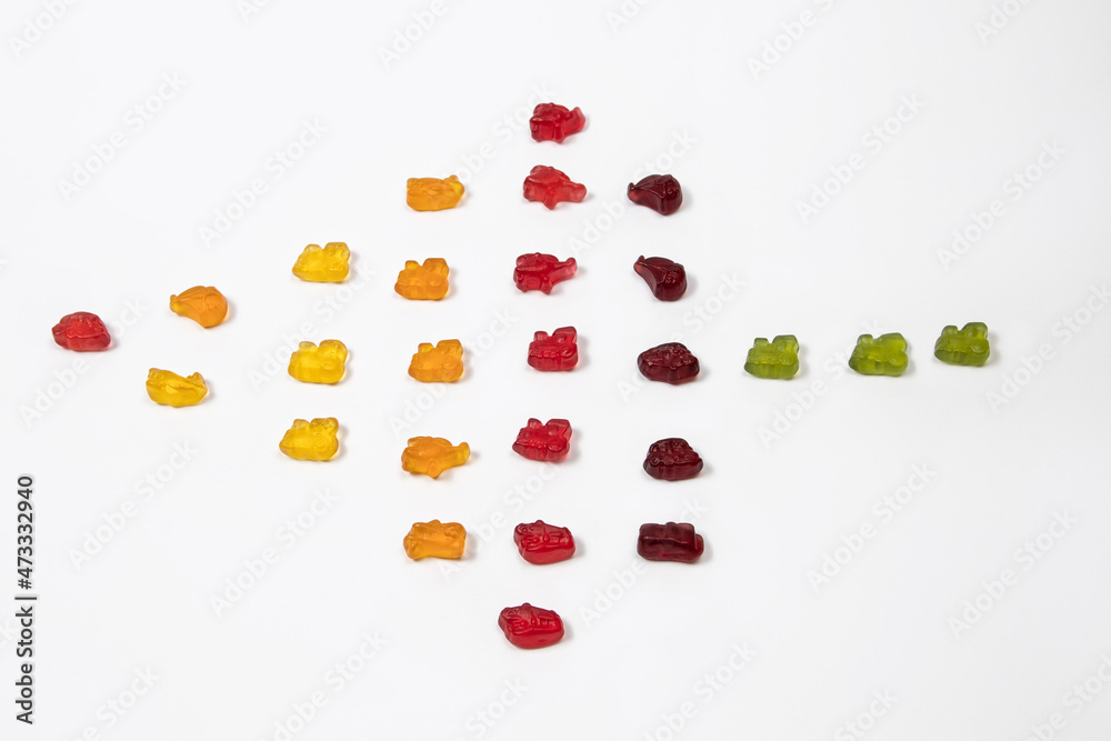 Colorful gummy candies arranged in the shape of an arrow