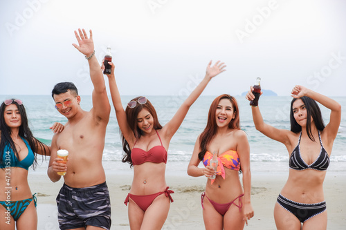 sexy bikini party seaside enjoy meeting group friends having fun dancing and drinking beverage on the beach, happy life on summer season