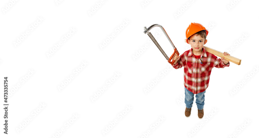 Flyer with funny little boy, kid in image of builder, architect in orange protective helmet posing with tools isolated on white background