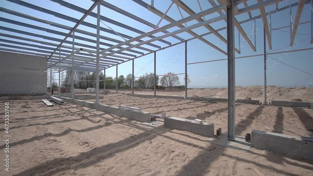 The building structure from the metal structures of the truss structure of the truss structure the building at the factory, construction site metal structure roof beams built development The building structure from the metal structures of the truss structure of the truss structure the building at the factory, construction site metal structure roof beams built development