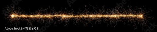 golden bright sparkler wide panorama tracer fuse line isolated dark black background. anniversary, pyrotechnics, wedding and happy birthday celebration party concept photo