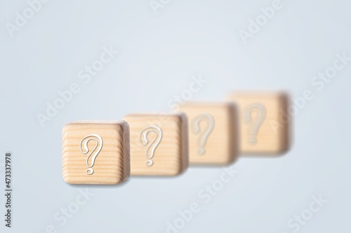wooden blocks with a question mark. frequently asked questions marketing plan for educational ideas