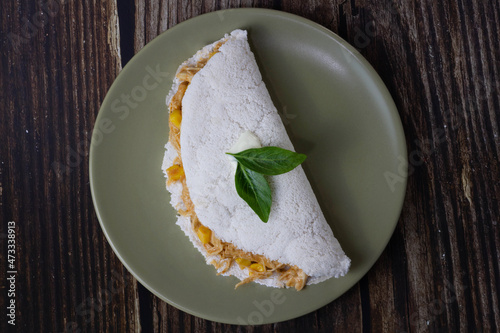 Chicken tapioca with corn. Basil leaf on top. Top view