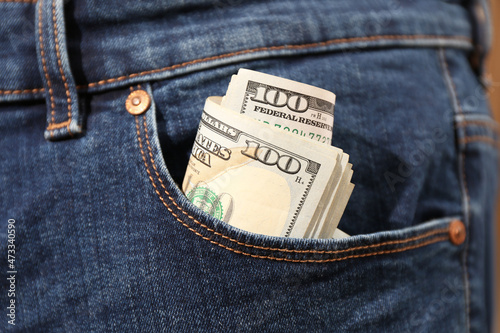 Tableau sur toile Dollar banknotes in pocket of jeans, closeup. Spending money