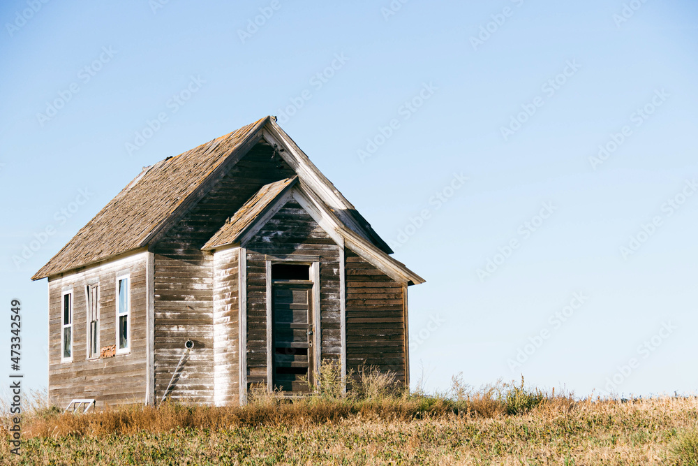 An old country church in the Great Plains during sunset with fall colors in North Dakota. An old country church in the Great Plains during sunset with fall colors in North Dakota.