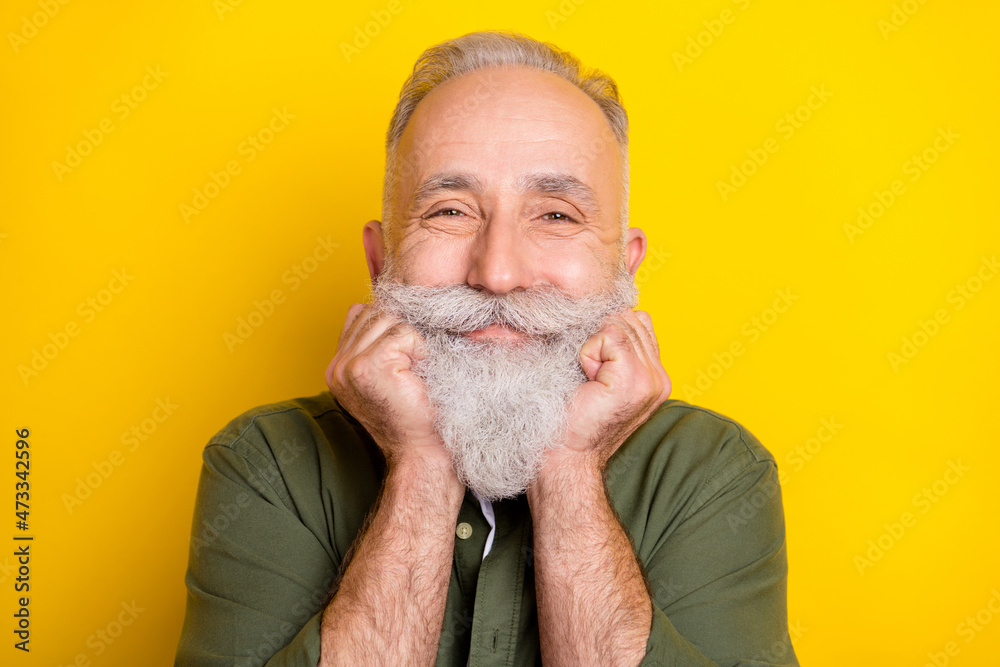 Photo portrait of senior man in green shirt smiling cheerfully isolated bright yellow color background
