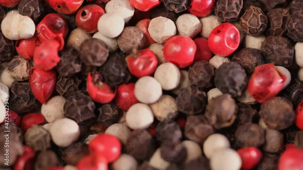 Mixed peppercorns rotation, heap of spice, mix of different peppers closeup, slow motion Mixed peppercorns rotation, heap of spice, mix of different peppers closeup, slow motion