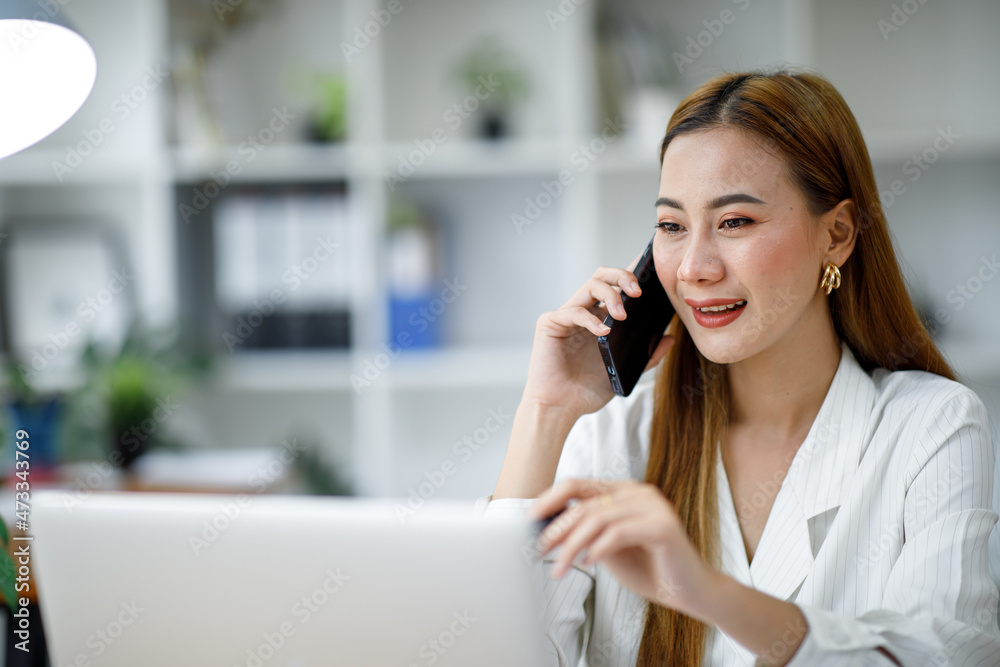 Confident businesswoman documents working on laptop at her workplace at modern office. reading financial report analyzing statistics pointing at pie chart working at her desk. Confident businesswoman documents working on laptop at her workplace at modern office. reading financial report analyzing statistics pointing at pie chart working at her desk.