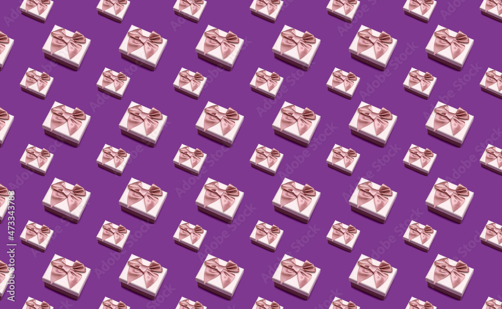 Gift box with a pink bow on a violet background. Gift box with a pink bow on a violet background.