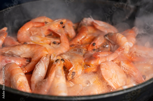 Close up of shrimps in frying pan. Close up of cooked prawns. Macro food background. Seafood