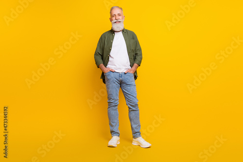 Full length body size photo of senior man smiling cheerful wearing stylish outfit isolated vibrant yellow color background