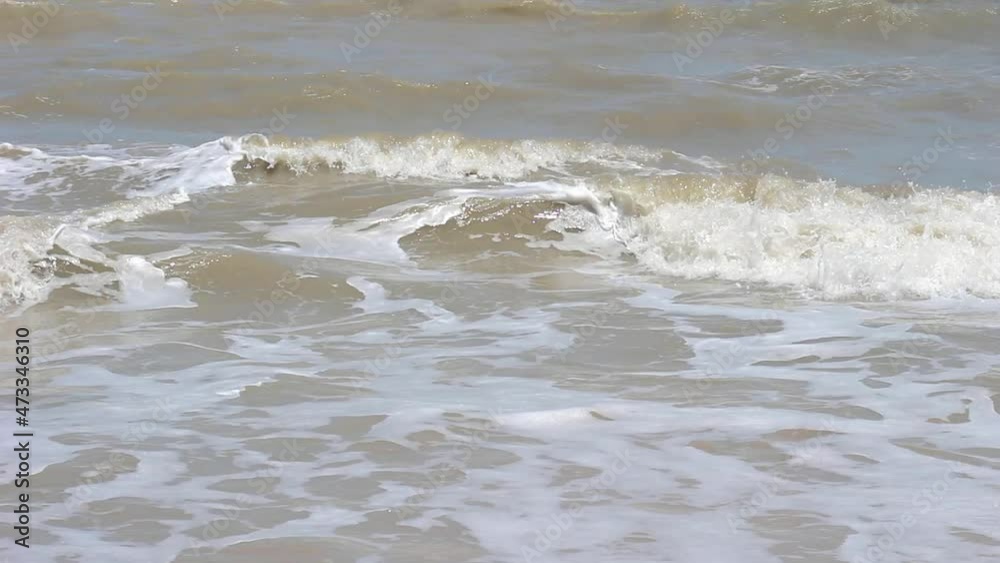 As the waves moves they create texture from white sea foam.selective focus. As the waves moves they create texture from white sea foam.selective focus.