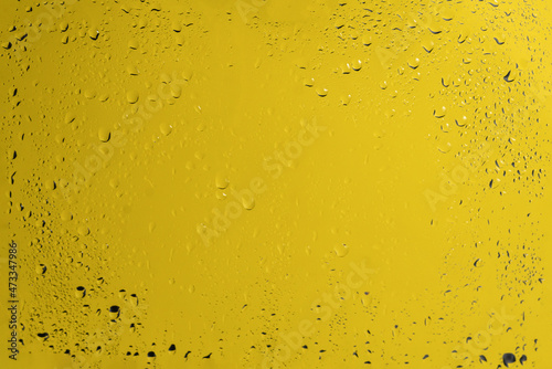 Yellow backgrond with water drops.