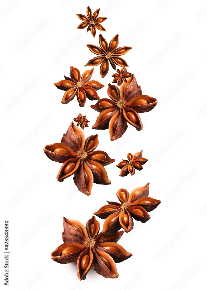 Dry aromatic anise stars falling on white background Dry aromatic anise stars falling on white background