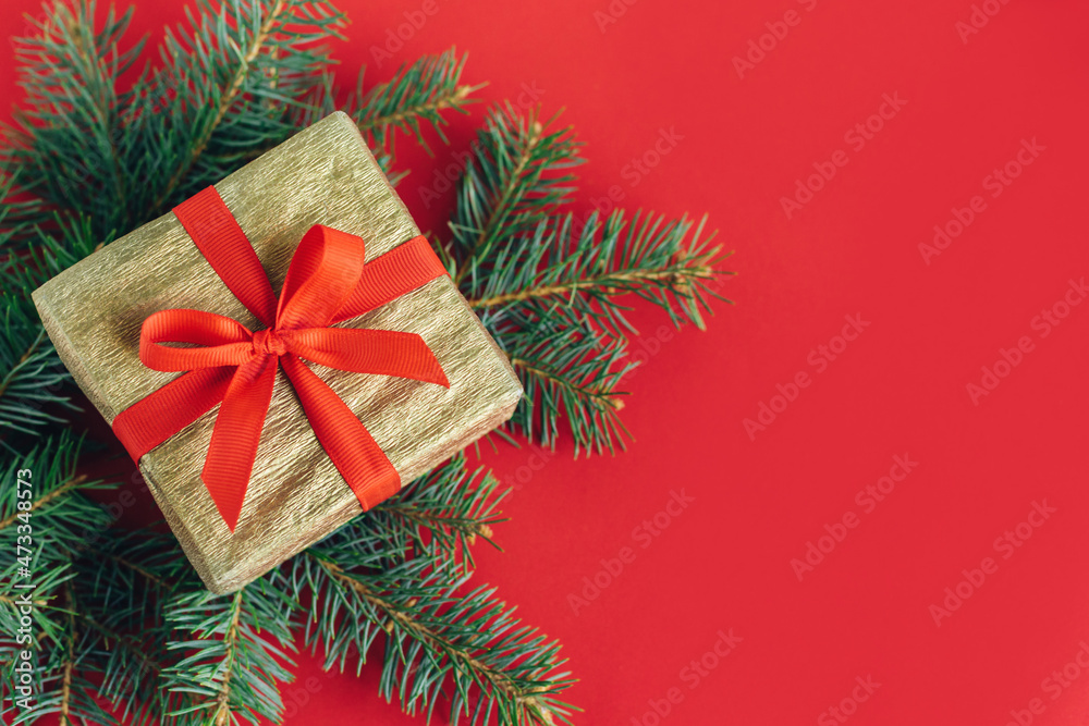 Gift box with spruce branches on a red background. Holiday concept. Gift box with spruce branches on a red background. Holiday concept.